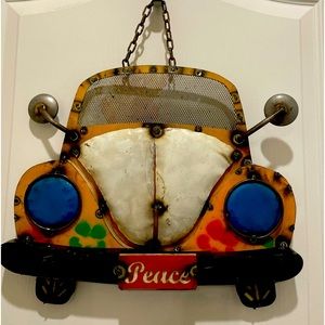 VW Beetle decoration.
Made of metal steel.
Yellow, blue and red. Wall decoration